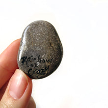 Load image into Gallery viewer, art of a silver gray maine coon cat as an angel, is hand painted on a river rock, and is available as either a keepsake, magnet or a pendant necklace. back signed with, rainbowofcrazy
