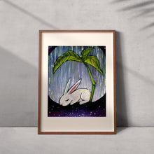 Load image into Gallery viewer, an art print featuring an illustration fo a white rabbit resting under a giant plant, under the rain. with a galaxy of stars below.
