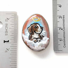 Load image into Gallery viewer, a small beach stone hand painted with the portrait of a beagle as an angel in the clouds, available as a keepsake or pendant necklace
