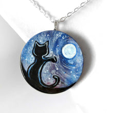 Load image into Gallery viewer, wood pendant hand painted with a black cat against a starry sky with the full moon
