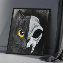 Load image into Gallery viewer, An art print split in half: the left side shows one side of a black cat's face, with a yellow eye, and the right side shows a stylized cat skull
