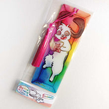Load image into Gallery viewer, A PET (polyethylene terephthalate) bookmark and red tassel with a small bead, featuring a character from Rainbow of Crazy Comics reading in a cozy, colourful box: a mini lop rabbit reads a book bear holding a hat on the cover. on the bottom, it says @ Rainbowofcrazy. The bookmark is packaged in a sleeve with a small band with the text "Rainbow of Crazy Comics bookmark"

