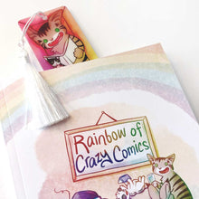 Load image into Gallery viewer, The cat bookmark peeking out of Rainbow of Crazy Comics, Volume One
