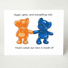 Load image into Gallery viewer, a greeting card with art of an orange gummy bear, holding the hand of a blue gummy bear, with the message, "Sugar, spice, and everything nice. That's what our love is made of"
