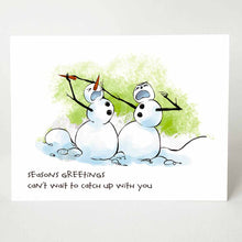 Load image into Gallery viewer, christmas card that says, "seasons greetings. can't wait to catch up with you" with an illustration of two snowman in a middle of a fight, with one pulling out the other's carrot's nose
