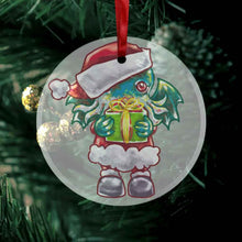 Load image into Gallery viewer, a round glass ornament, printed with an illustration of cthulhu dressed as santa clause, holding a present up for you
