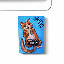 Load image into Gallery viewer, blue wood magnet, hand painted with an orange cat with its tongue out. near the top of the cat's head is the word CLEAN. a black bar covers the cat's crotch and says the word DIRTY. around the bar, the cat's body is pixelated
