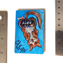 Load image into Gallery viewer, blue wood magnet, hand painted with an orange cat with its tongue out. near the top of the cat's head is the word CLEAN. a black bar covers the cat's crotch and says the word DIRTY. around the bar, the cat's body is pixelated
