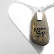 Load image into Gallery viewer, a beach stone hand painted with a portrait of a smiling doberman dog
