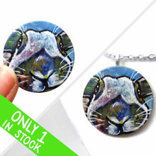 Load image into Gallery viewer, a small round wood disc, hand painted with a portrait of an English Spot rabbit, face up close, painted in rainbow colours. it's available as a keepsake or pendant necklace
