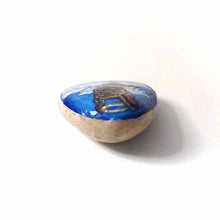 Load image into Gallery viewer, a small beach stone, hand painted with a portrait of a brindle french bulldog, as an angel in the clouds.

