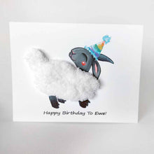 Load image into Gallery viewer, a greeting card featuring an illustration of a smiling black sheep with white fleece, wearing a rainbow party hat. its fleece is made with thick, chunky, white yarn. the front reads, "Happy Birthday to Ewe!"
