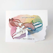 Load image into Gallery viewer, a greeting card with art of an English spot rabbit. the bottom right of the card has been ripped off and hangs from the rabbit's mouth. "I got you a card! ... but I eated it"
