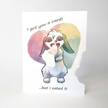 Load image into Gallery viewer, a greeting card with art of an mini lop rabbit. a piece from the of the right side of card has been ripped off and hangs from the rabbit's mouth. "I got you a card! ... but I eated it"

