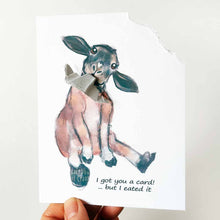 Load image into Gallery viewer, a funny greeting card with a black and brown sheep sitting upright, with the top right corner of the card ripped and hanging from its mouth. the card reads, "I got you a card! ... but I eated it"
