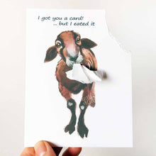 Load image into Gallery viewer, a funny greeting card with a brown and black sheep, with the top right corner of the card ripped and hanging from its mouth. the card reads, "I got you a card! ... but I eated it"

