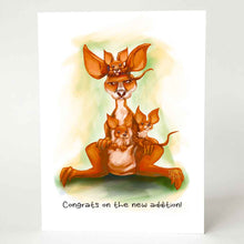 Load image into Gallery viewer, a greeting card, illustrated with a very unimpressed kangaroo, with three joeys holding on. it reads "congrats on the new addition!"
