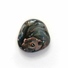 Load image into Gallery viewer, a smooth, flat, beach stone hand painted with a smiling hippopotamus
