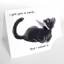 Load image into Gallery viewer, a greeting card, with an illustration of a sitting black cat. the bottom right corner of the card is ripped off and hangs from the cat's mouth. card reads, "I got you a card... But i eated it"
