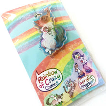 Load image into Gallery viewer, A clear, rainbow holographic acrylic keychain featuring a character from Rainbow of Crazy Comics: a smiling fluffy ragdoll cat, lying on her back, with a tiny black-capped chickadee, the bird perched on the cat's ear. The keychain is packaged with a backing card, decorated with a rainbow, and the text "Rainbow of Crazy Comics", along with the character cast.
