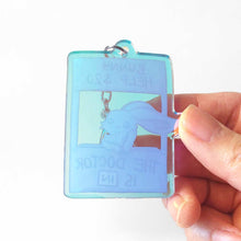 Load image into Gallery viewer, Back of the rabbit acrylic keychain, printed on a blue tinted acrylic.
