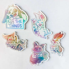 Load image into Gallery viewer, Five acrylic fridge magnets featuring animals from Rainbow of Crazy Comics. 1. A mini lop rabbit holds up a sign that says "BUY THE THINGS". 2. A white rabbit leans against a sign that says "Just a Note". 3. A tabby cat holds up a sign that says "HYDRATE PLEASE". 4. A ragdoll cat holds a sign that says "REMEMBER PLEASE". 5. An English spot rabbit holds a sign that says "THINGS TO DO."
