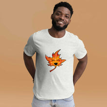 Load image into Gallery viewer, a person wears a t-shirt in the colour ash (very light grey) featuring a graphic of a smiling maple leaf
