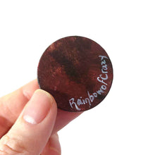 Load image into Gallery viewer, a lightweight wood disc, hand painted with a portrait of a red baby octopus. the painting is available as a keepsake, or pendant necklace. back is signed with, Rainbowofcrazy
