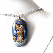 Load image into Gallery viewer, an oval shaped beach stone, hand painted with the portrait of an orange munchkin cat as an angel. standing up on clouds against a royal blue sky. available at a keepsake or pendant necklace
