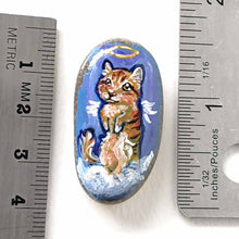 Load image into Gallery viewer, an oval shaped beach stone, hand painted with the portrait of an orange munchkin cat as an angel. standing up on clouds against a royal blue sky. available at a keepsake or pendant necklace

