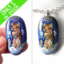 Load image into Gallery viewer, an oval shaped beach stone, hand painted with the portrait of an orange munchkin cat as an angel. standing up on clouds against a royal blue sky. available at a keepsake or pendant necklace
