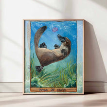 Load image into Gallery viewer, an art print of the page of cups tarot card, from the animism tarot deck: a platypus swims in the ocean, playing with a purple lotus flower, with seaweed swaying below
