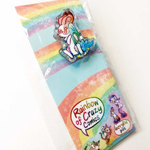 Load image into Gallery viewer, A glittery acrylic pin featuring a character from Rainbow of Crazy Comics: Linus an English spot rabbit, smiles as he cuddles a light blue blanket. packing includes a backing board featuring other "Rainbow of Crazy Comcis" characters
