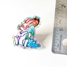 Load image into Gallery viewer, A glittery acrylic pin featuring a character from Rainbow of Crazy Comics: Linus an English spot rabbit, smiles as he cuddles a light blue blanket.

