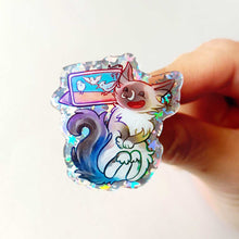 Load image into Gallery viewer, An acrylic pin featuring a character from Rainbow of Crazy Comics: a glittery pin of a smiling birman cat watching a bird video on a tablet.
