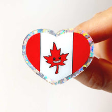 Load image into Gallery viewer, A glittery acrylic pin featuring a character from Rainbow of Crazy Comics: the Canada flag with a stylized maple leaf with happy face.
