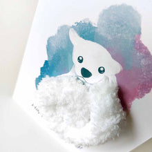 Load image into Gallery viewer, a greeting card with an illustration of a polar bear. thick, fluffy white yarn makes up the bear's body. the background has a splash of blue and purple. the front says, "Happy Bear-day!"
