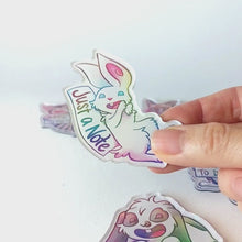 Load and play video in Gallery viewer, Video of a hand tilting the white rabbit magnet back and forth to showcase the holographic finish.
