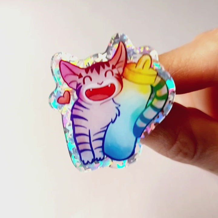 An acrylic pin featuring a character from Rainbow of Crazy Comics: a smiling tabby cat snuggling up to a large water bottle. a small heart appears next to the cat.