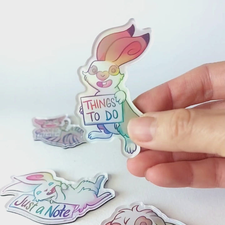 Video of a hand tilting the rabbit magnet back and forth to showcase the holographic finish.