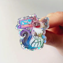 Load and play video in Gallery viewer, hand gently tilting an acrylic pin of a smiling ragdoll cat watching birds on a tablet to show the glitter effect
