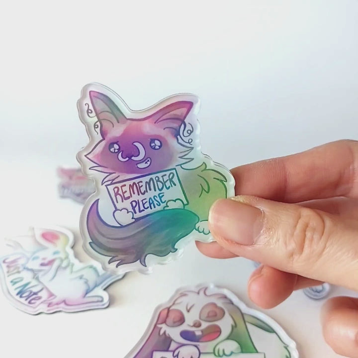 Video of a hand tilting the cat magnet back and forth to showcase the holographic finish.