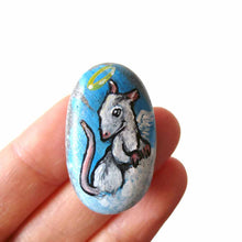 Load image into Gallery viewer, a pet portrait of a white and grey rat as an angel on clouds, painted on a beach rock. available as a beach stone, fridge magnet, or a pendant necklace

