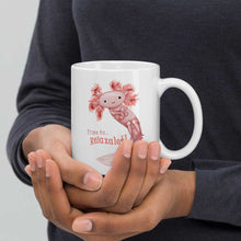 Load image into Gallery viewer, hands holding a white ceramic mug, 11 oz size, with an illustration of a smiling axolotl next to the text "Time to.. Relaxalotl"
