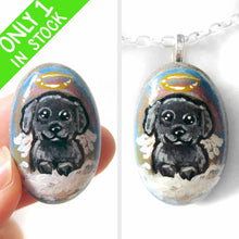 Load image into Gallery viewer, A small beach stone, hand painted with a portrait of a black shih tzu dog as an angel sitting in the clouds. Available as a keepsake, fridge magnet, or necklace
