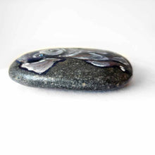 Load image into Gallery viewer, a small beach stone hand painted with the portrait of a silver labrador retriever puppy with blue eyes.
