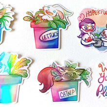 Load image into Gallery viewer, A variety of stickers featuring rabbit and cat characters from Rainbow of Crazy Comics, each in a potted plant. One shows a cat in a pot labelled CAT GRASS, one a rabbit in a pot labelled LETTUCE
