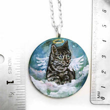 Load image into Gallery viewer, a small wood disc, hand painted with the portrait of a gray tabby cat, as an angel with wings and halo, sitting on clouds against a blue sky. this painting is available as a keepsake or pendant necklace
