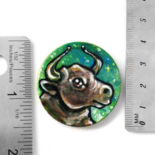 Load image into Gallery viewer, wood pendant hand painted with a bull (taurus) against a starry green background. 1.5" piece
