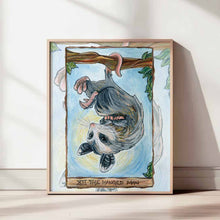 Load image into Gallery viewer, an art print of the hanged man tarot card, from the animism tarot: an opossum hangs upside down from a tree branch.
